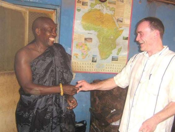 Two men from West Africa shaking hands.