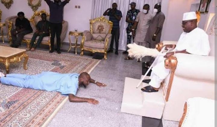  A young man lying down to greet a leader in Yoruba.