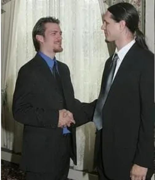 Two young American men are shaking hands.