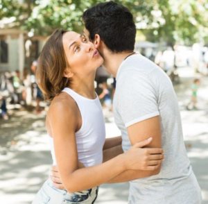 Two young people share a Spanish embrace.