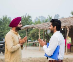 Two young Indian men greeting, "Namaste."