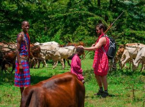 Tourist interacts with the Maasai in the Mara.