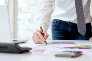 A man writing on a note pad